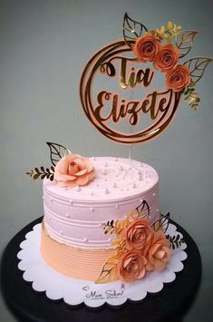 there is a cake with flowers on it and a sign that says tia elzey