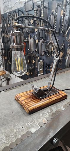 a desk lamp sitting on top of a wooden cutting board next to a metal wall