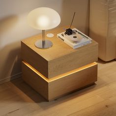 a wooden table with a white light on top and a record player sitting on it