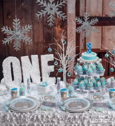 a table topped with blue and white desserts covered in frosted snowflakes