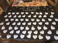 there is a sign that has been decorated with paper hearts on clothes pins and the words, why we love barbara