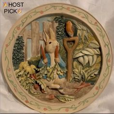 a plate with a painting of a rabbit holding a tree