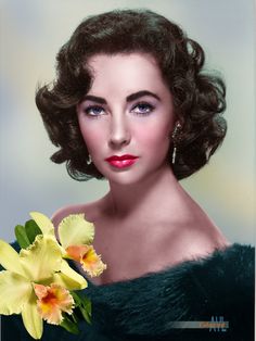 a woman with flowers in her hair is posing for the camera and wearing a fur coat