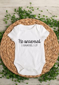 a white onesuit with the words he answered and samuel 11 27 printed on it