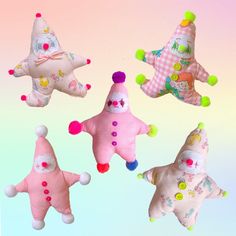 four stuffed toys are in the shape of stars