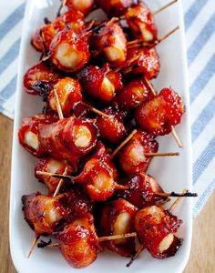 bacon wrapped in toothpicks on a white plate