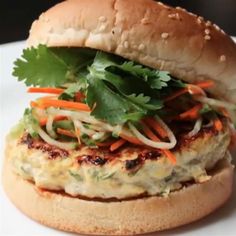 a chicken burger with lettuce and carrots