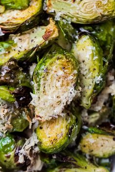 brussel sprouts with parmesan cheese on top in a white bowl