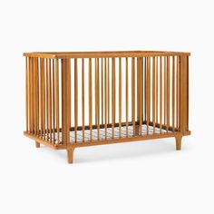 a small wooden crib on a white background