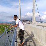 a man standing on the side of a bridge