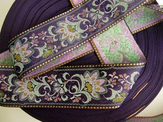 purple and green ribbon with floral designs on it