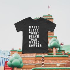 ★ HOME OF THE ORIGINAL CHARACTER TEE SINCE 2016 ★ The perfect tee to wear while exploring Mario World at Universal! Whether you're vacationing at Universal Studios or having a Mario themed birthday party our best selling Mario character shirts are sure to be a show stopper! This collection is available in sizes for the whole family - perfect for magical and memorable photos! ★ PRODUCT DETAILS ★ This collection is available in infant, toddler, kids and adult sizes and perfectly matched in color. Mario Themed Birthday Party, Universal Trip, Trip Outfit, Mario Birthday, The Originals Characters, Trip Outfits, Original Character, Themed Birthday Party, Toddler Kids