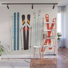 the skis are lined up against the wall in this room with wood flooring