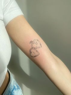 a woman's arm with a tattoo that has the letter b on it and a heart