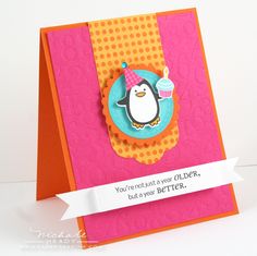 a birthday card with a penguin holding a cupcake