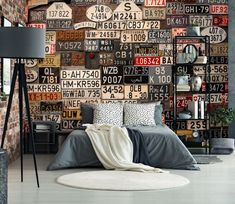 a bedroom with lots of license plates on the wall