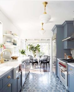 an image of a kitchen with blue cabinets and tile flooring on the walls, along with text that reads kitchen unusual dark blue gray grey kitchen cabinets