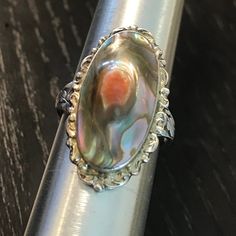 An antique Blister pearl early 1900s sterling ring.  Size 6 3/4.  Condition I see no problems, center choice conch shell in high relief is bezel set, marked sterling.  Scalloped sterling gallery frames this lustrous treasure from the sea.  Art nouveau shank 1 1/8" north to south on finger. Antique Silver Pearl Ring, Antique Oval Pearl Ring Collectible, Vintage Hallmarked Silver Pearl Ring, Vintage Silver Hallmarked Pearl Ring, Vintage Silver Oval Pearl Ring, Vintage Silver Pearl Ring With Hallmark, Handmade Vintage Pearl Ring In Sterling Silver, Handmade Vintage Sterling Silver Pearl Ring, Antique Silver Oval Pearl Ring