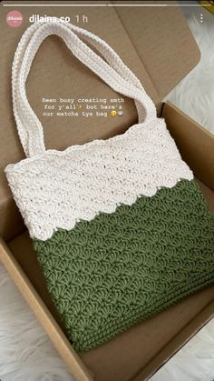 an open box with a crocheted bag inside