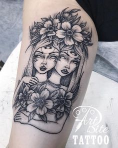 a woman with flowers on her head is shown in black and white tattoo art work