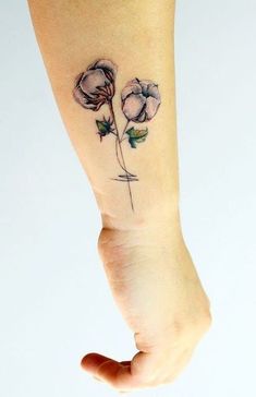 a woman's foot with a flower tattoo on it