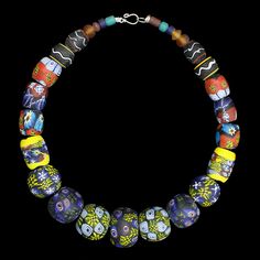 A large necklace comprising of glass bead replicas from Eidem, Norway. Wear as a standalone necklace, or attach between tortoise brooches. For Viking men or women. Total length: approx 50cm (19.7 inch). Beads range from 5mm - 30mm (0.2 - 1.2 inch) wide. Metal clasp for easy closure. Hand-painted & plain glass replica beads from 9th - 10th century Norway. Total weight approx. 302g (10.65oz) approx. Last image shows the original necklace from the museum of Norway. Vintage Glass Necklaces With Oval Beads, Vintage Glass Necklace With Oval Beads, Artisan Glass Bead Necklaces, Artisan Glass Beaded Necklaces, Artisan Glass Necklaces With Round Beads, Artisan Glass Necklaces With Oval Beads, Glass Necklace With Large Round Beads, Artisan Necklace With Polished Glass Beads, Traditional Glass Necklace For Gift