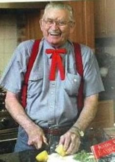 an old man in the kitchen making food