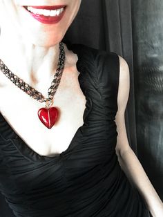 Sweet & sexy - this darkly romantic red heart pendant necklace features an over-sized, gloriously-glossy, ABSOLUTELY EXQUISITE heart pendant made of stunning Venetian glass. This specialty gold-foil-lined glass is artisan-made on the island of Murano, a neighbor of nearby Venice, Italy. The rich, deep regal-red heart is bound in oxidized sterling silver wire and suspended between double-strands of lustrous and weighty gunmetal-plated chain with large oval links. The hefty black lobster claw Red Heart Pendant Necklace, Red Heart Pendant, Four Eyes, Venetian Glass, Glass Heart, Oxidized Sterling Silver, Big Love, Venice Italy, Heart Pendant Necklace