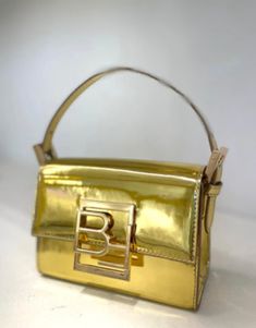 Decorated with BY FAR’s initials in gold, this mini bag has a classic box shape and a structured yet spacious interior. The top-handled style is made modern by distinctive semi patent leather – a signature material for the brand. Enriched with an adjustable shoulder strap in matching leather for different ways to wear. Calfskin leather exteriorAdjustable, detachable leather handleAdditional adjustable leather strapBranded hardwareBF logo on the flapSingle interior pocket Trendy Gold Shoulder Bag For Formal Occasions, Square Box Bag With Branded Hardware For Evening, Formal Square Box Bag With Branded Hardware, Designer Gold Box Bag With Double Handle, Gold Box Bag With Top Handle For Party, Gold Party Box Bag With Top Carry Handle, Chic Rectangular Bag With Gold-tone Logo Plaque, Chic Rectangular Shoulder Bag With Gold-tone Logo, Gold Rectangular Bag With Gold-tone Logo Plaque