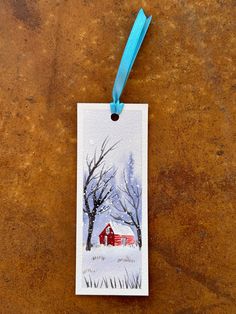 a tag with a red barn and trees on it