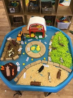 a blue tray filled with lots of different types of toys