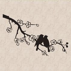 the silhouette of a bird on a branch with flowers in it's beaks