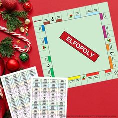 a monopoly board game surrounded by christmas decorations and candy canes on a red background