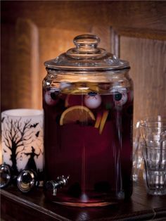 a glass jar filled with liquid sitting on top of a table