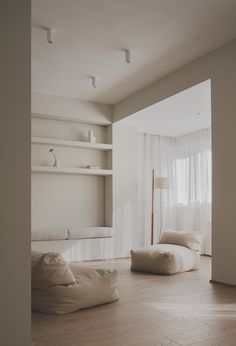 a living room filled with furniture and white walls