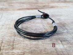 Details: *Listing for set of 4 bracelets *Meterial - Bracelet A: 1mm black leather cord with coconut button - Bracelet B: 2mm black leather cord with wooden bead - Bracelet C: 6mm lava bead with black waxed cord and sliding knot for closure - Bracelet D: 4mm round matte onyx beads with black waxed cord and sliding knot for closure Size: Choose your size from the drop-down menu. *✈️ Shipping.. The item shipped by registered airmail Thailand Post within 3-5 working days after payment received. - U Minimalist Handmade Black Leather Bracelet, Minimalist Adjustable Leather Bracelet With Black Band, Adjustable Black Leather Bracelet With Sliding Knot, Black Leather Bracelet With Adjustable Cord As Gift, Minimalist Black Adjustable Wrap Bracelet, Adjustable Black Leather Bracelet With Waxed Cord, Black Waxed Cord Leather Bracelet Gift, Men Leather Bracelet, Mens Bracelet Black