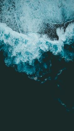 an aerial view of the ocean with waves