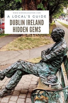 a bronze statue sitting on top of a park bench