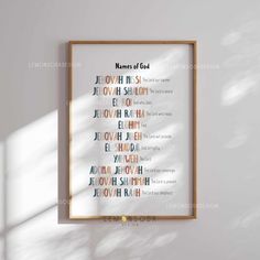 a framed poster hanging on the wall in front of a white wall with words written below it