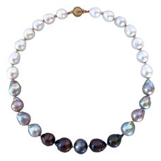 Gorgeous yet simple piece from Marina J. This beautiful necklace features high luster Baroque Black, Grey and White Pearls all carefully strung together to create the perfect ombre. Pearls graduate in size from light to dark, giving this piece a dynamic and dimensional look. Each Pearl displays a wild iridescent "oilspill" sheen and is accented by a 14K Yellow Gold cups. Necklace meets at a secure and decorative 14K Yellow Gold Bead Closure Clasp and measures 17.5 inches long, allowing it to sit Ombre Necklace, South Sea Pearl Necklace, Akoya Pearl Necklace, Necklace Clasp, Pearl Strands Necklace, Golden South Sea Pearls, J Black, Necklace Clasps, Emerald Necklace