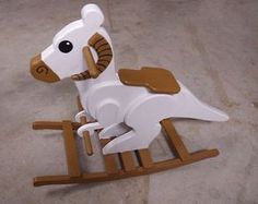 a wooden rocking horse on the ground