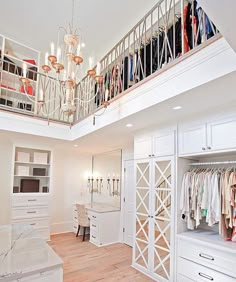 the closet is full of clothes and chandelier in this home's bedroom