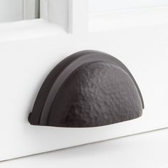 a close up of a door handle on a white door with a black metal knob