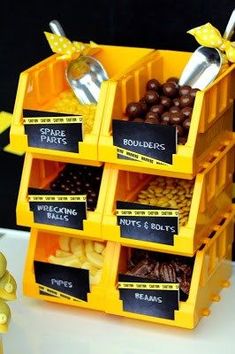 a stack of yellow containers filled with chocolate candies