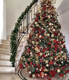 a christmas tree is decorated with red and gold ornaments