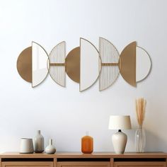 three circular mirrors mounted on the wall above a dresser with vases and other items