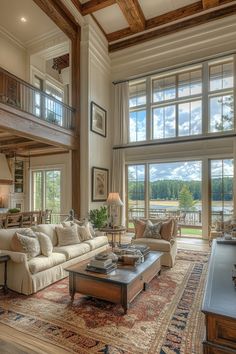 a large living room with high ceilings and wooden beams on the ceiling is filled with furniture