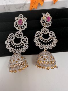 American Diamond Finish Color Stone Jhumka Earings - Red Red Hand Set Chandbali Jhumkas, Red Chandbali Hand Set Jhumkas, Red Chandbali Jhumkas With Hand Set, Red Hand Set Chandbalis For Celebration, Heavy Red Ruby Earrings, Red Hand Set Jhumkas For Celebration, Red Stone Work Jhumkas For Diwali, Red Stone Work Earrings For Festivals, Bollywood Style Red Ruby Earrings