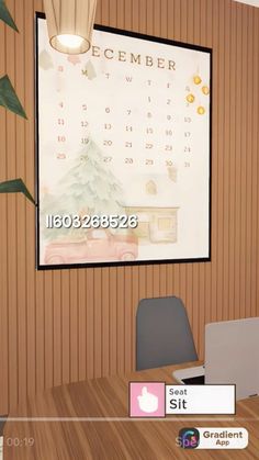 a computer desk with a calendar on the wall