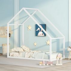 a child's bedroom with blue walls and white furniture, including a doll house bed